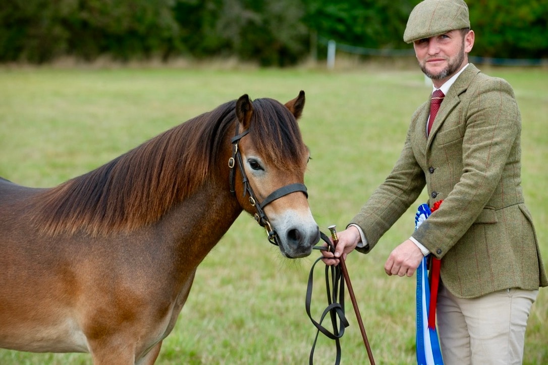 Darshill Logan with handler and rosettes